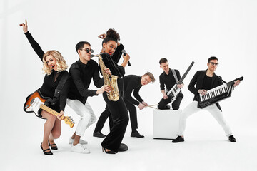 Entertaining concept, teamwork. International group of musicians on a white background, guitarist,...