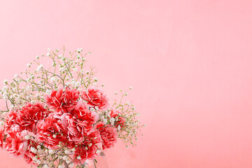 Floral arrangement with carnations on a pink background. Concept for Valentine's Day or Women's...