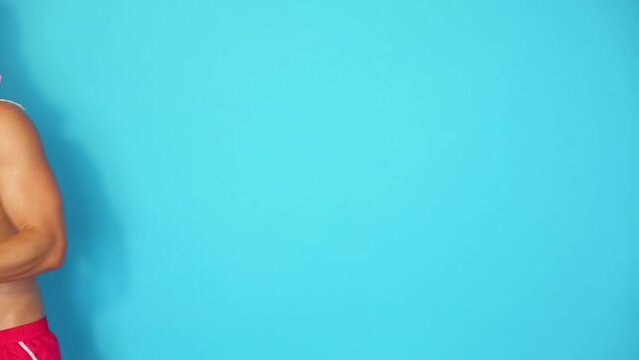 Half-naked man in pink fur cap and sunglasses dances and moves
