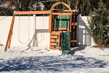 swing set in snow - Powered by Adobe