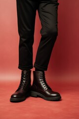 a person wearing a pair of black fashion boots
