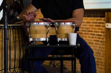 A man plays the bongo drums.