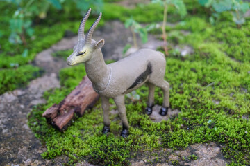 Toy Antelope on Green Moss Outdoor Setting