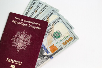 Closeup view of french passport and us dollar banknotes.