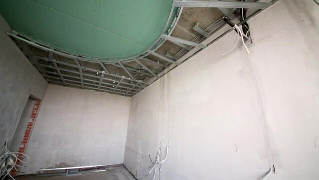Room with sticking out wires and mounted false ceiling.