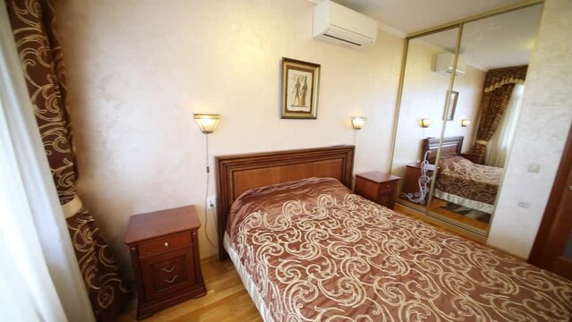 Interior of a hotel bedroom with double bed and TV in guest house