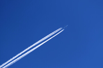 airplane trail in the clear blue sky