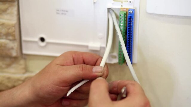 hands twist screen braid during preparing cable to installation.