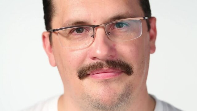 Close up portrait of man with mustache winks and looks up