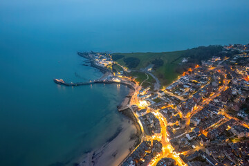 Fototapeta premium Aerial night view of the famous travel destination, Swanage, Dorset, South West England. blue hour winter