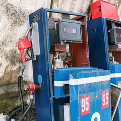 Fotobehang Abandoned fuel pump with red fuel nozzle. Energy crisis concept © Demetrio