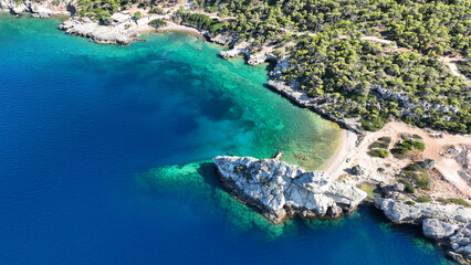 Fototapeta na wymiar Aerial drone photo of not so famous but paradise secluded sterna beach with crystal clear emerald sea near iconic lake Vouliagmenis, Loutraki, Greece