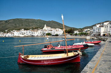 Small red boats at Port Cadaqués, commune on the Costa Brava at northeastern Catalonia in Spain