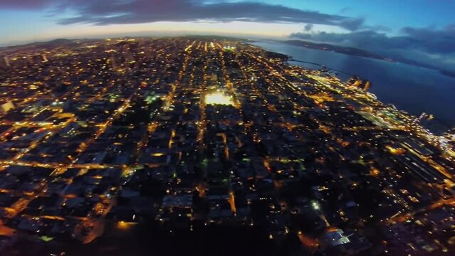 Panorama of coast city with illumination at evening. Aerial view