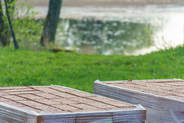 Fototapeta premium Laying paving slabs on a construction site. Repair of a road or sidewalk. The new paving slabs are neatly stacked in boxes.