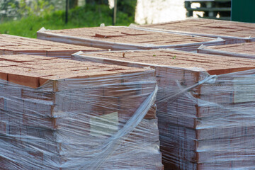 Laying paving slabs on a construction site. Repair of a road or sidewalk. The new paving slabs are neatly stacked in boxes.