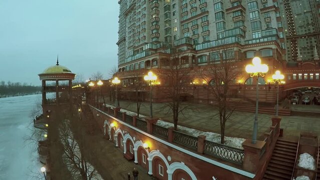 Illuminated quay near residential complex Scarlet Sails at winter