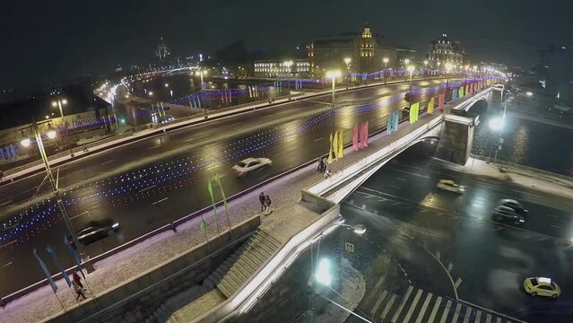 Cars ride by Bolshoy Moskvoretsky bridge with illumination