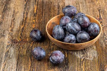Wet purple plum on the table, fresh harvest