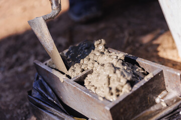 Technician worker checking of concrete quality during cube test on building site