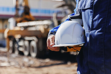 Worker engineer hold hard hat background of concrete mixer pouring foundation. Banner building...