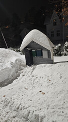 A huge snowbank in front of the mailboxes