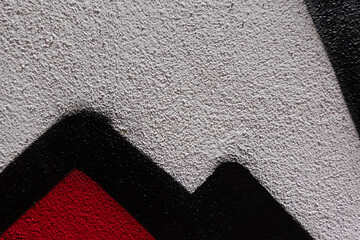 Abstract wall surface with part of graffiti. Geometric lines, white, black, red colors background