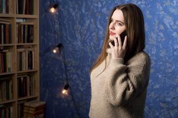 a woman of European appearance is talking on a smartphone.
