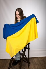 a woman of Slavic appearance with a Ukrainian flag