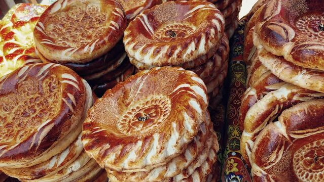 Tortillas on the market in Samarkand, Uzbekistan - June 29, 2023: Goods and traders at the Oriental Bazaar in Uzbekistan. Siab Bazaar is the largest and oldest bazaar in Samarkand. 4K