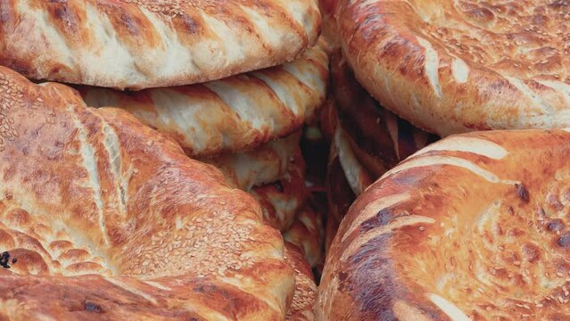 Tortillas on the market in Samarkand, Uzbekistan - June 29, 2023: Goods and traders at the Oriental Bazaar in Uzbekistan. Siab Bazaar is the largest and oldest bazaar in Samarkand. 4K