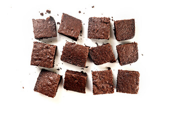 Many pieces of fresh chocolate brownie on a white table. Homemade delicious chocolate pie