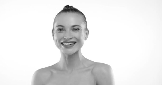 Monochrome image featuring a smiling model with a sleek bun hairstyle, portraying elegance and simplistic beauty in a stock photo perfect for beauty and fashion editorial use. Camera 8K RAW. 