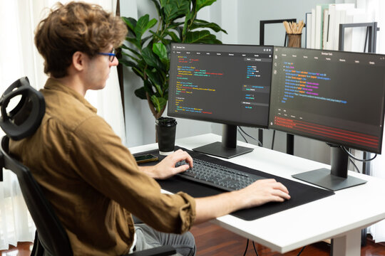 Working IT developer with stressful overworked in creating online software development coding on pc screen, thinking program for latest version application on website project at modern office. Gusher.