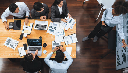 Top view multiracial analyst team use BI dashboard display on laptop screen, analyzing financial data for strategic decision. Fintech analyzes marketing indicators. Concord