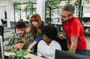 An interracial team is working on business strategy at the office.