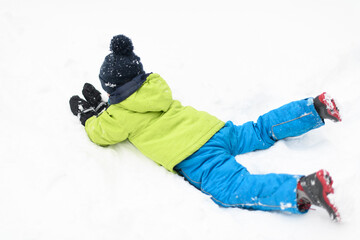 Fototapeta na wymiar Little Boy Having Fun in the Snow