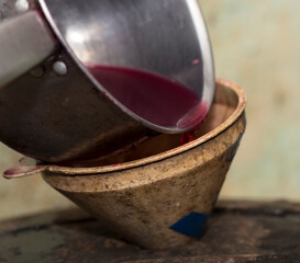 Wine making. Fresh grape juice is poured through a funnel into a barrel. Harvest home. Technology...