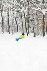 Young Boy Enjoying Himself While Playing in Snow