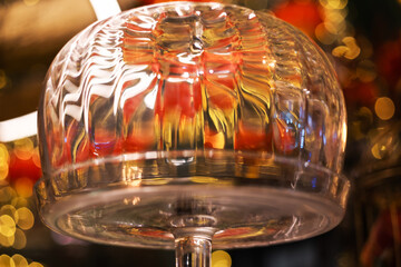 Refraction of electric light in glass cover on stand for cakes and pastries, cake tin in the interior of  cafe or restaurant decorated with red and golden Chinese lanterns for Lunar New Year