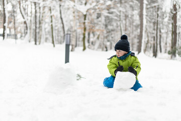 Fototapeta na wymiar Young Boy Enjoying Himself in the Snow