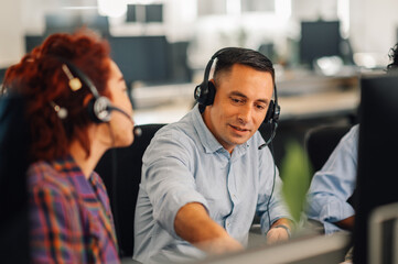 Portrait of a middle aged caucasian man working in a call center - obrazy, fototapety, plakaty
