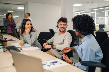 Portrait of a customer services agents with headset working in an office