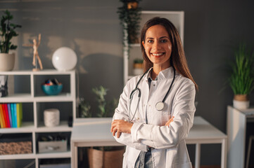 Proud professional female medical worker posing in her office
