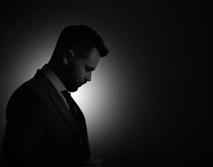 Silhouette of man in darkness. Portrait on black background