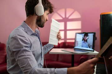 Man Teaching Piano Music Lesson With Remote Video Connection