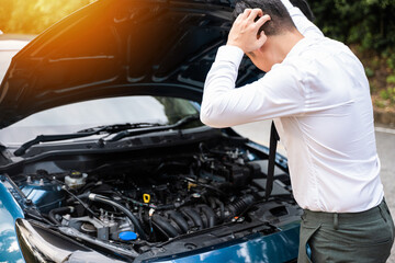 Asian businessman car broken breakdown, angry young stressed man stands trouble car failure problem looking in frustration at failed engine in morning, accident on road outdoor, late for business work