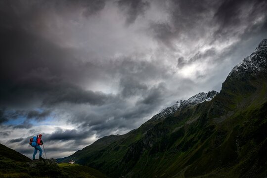Mountaineer with backpack on stone in the background Potsdamer Huette, Sellrain, Innsbruck, Tyrol, Austria, Europe