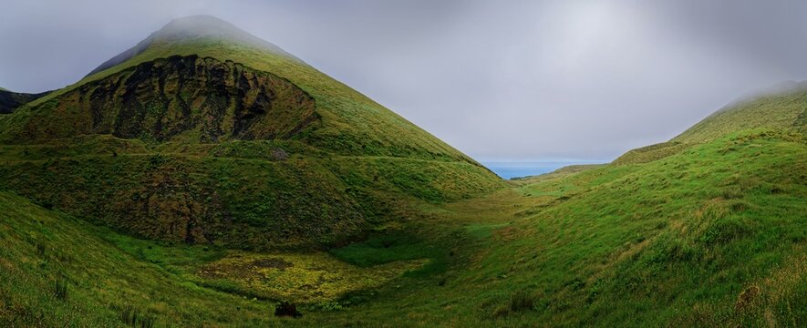 Green overgrown volcanic landscape and cones in the fog, Estradas dos Lagoas, Madalena, Pico, Azores, Portugal, Europe