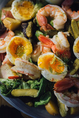 salad with hardboiled eggs, shrimp, pickles, butter lettuce, fennel bulb